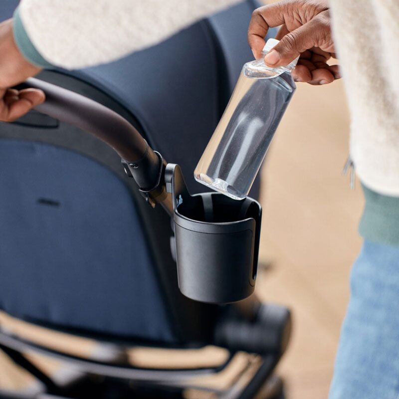 Joolz Cup Holder Black mounted on pushchair handlebar with drink