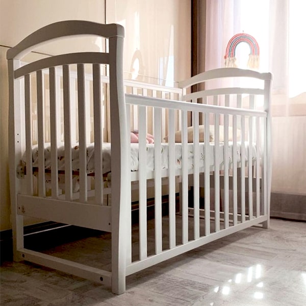 Children cot with drop side