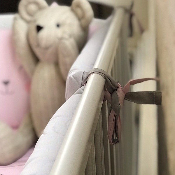 Cot with teething rail