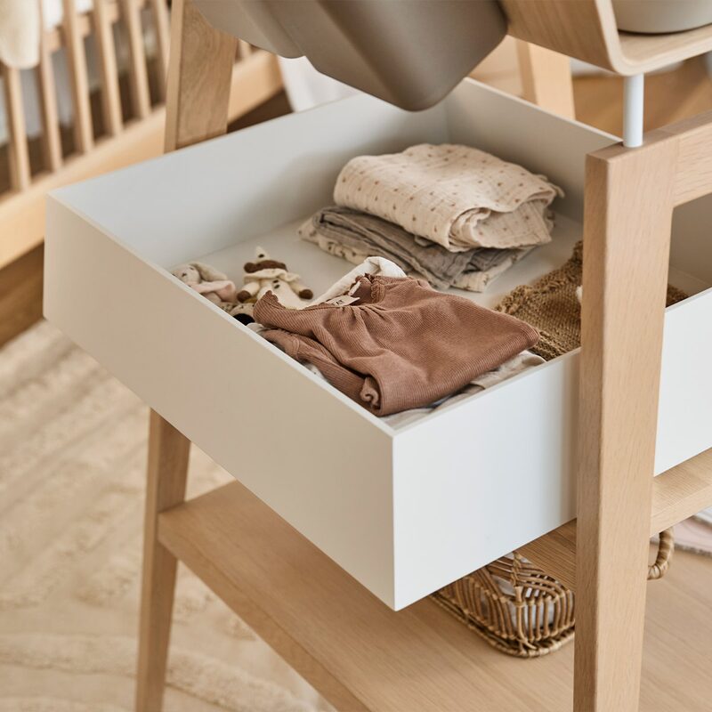 Leander Linea drawer White — close-up with baby clothes inside