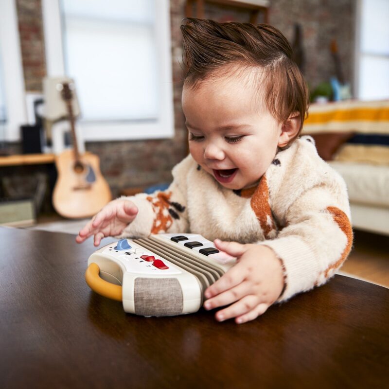 Child playing the Tiny Love Tiny Rockers electronic accordion