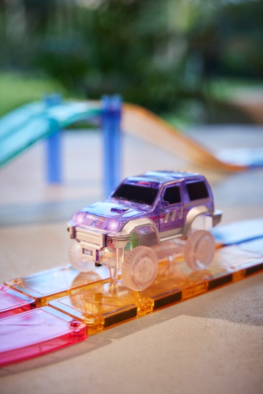 Cleverclixx Pastel Purple car driving along a magnetic Race Track